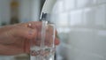 Man Fill Up a Glass With Fresh Water From Kitchen Faucet