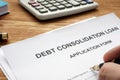 Man filling in Debt consolidation loan.