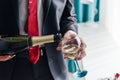 Man filling decorated glass with champagne