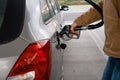 man filling fuel tank of his car with diesel fuel at the gas station close up, as cost of fuel going up Royalty Free Stock Photo