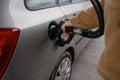 man filling fuel tank of his car with diesel fuel at the gas station close up, as cost of fuel going up Royalty Free Stock Photo