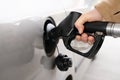 man filling fuel tank of his car with diesel fuel at the petrol station close up, as cost of fuel going up Royalty Free Stock Photo