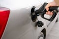 man filling fuel tank of his car with diesel fuel at the petrol station close up, as cost of fuel going up Royalty Free Stock Photo