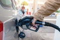 man filling fuel tank of his car with diesel fuel at the petrol station close up, as cost of fuel going up Royalty Free Stock Photo