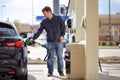 Man filling gasoline fuel in car Royalty Free Stock Photo