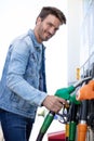 man filling gasoline fuel in car holding nozzle Royalty Free Stock Photo