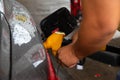 Man filling gasoline fuel in car holding pump. Royalty Free Stock Photo