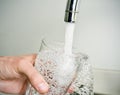 Man filling a glass of tap water
