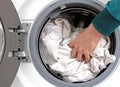 Man filling laundry in the washing machine