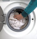 Man filling laundry in the washing machine