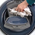 Man filling laundry in the washing machine