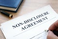 Man filling in Non-Disclosure Agreement NDA. Royalty Free Stock Photo