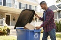 Man Filling Recycling Bin On Suburban Street Royalty Free Stock Photo