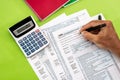 Man filling tax form with pen, calculator Royalty Free Stock Photo