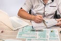 Man filling 1040 tax form at workplace. Performing tax calculations. Close up Royalty Free Stock Photo