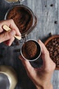 Man fills with coffee the funnel of a moka pot