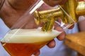 A man fills a plastic glass with beer