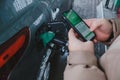 Man fills up his car with gas and pays with his smartphone Royalty Free Stock Photo