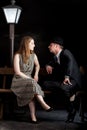 Man Film noir couple street lantern bench Royalty Free Stock Photo