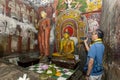 A man films inside Cave One (Devaraja Viharaya) at the Dambulla Cave Temples in Sri Lanka.