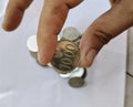 A man finger holding a Indonesian Coin