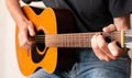 Man finger picking an Acoustic Guitar