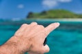 Man finger pointing to beautiful island. Discovery, travel and holiday concept Royalty Free Stock Photo