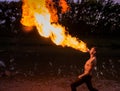 Man fire-eater blowing a large flame Royalty Free Stock Photo