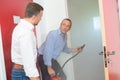 Man with fire extinguisher at doorway smoke filled room Royalty Free Stock Photo