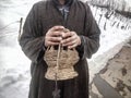 A man with fire pot to warm his hands