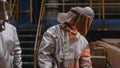 A man in a fireproof suit stands in the smelting shop of a metallurgical plant.