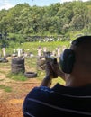 Man firing pistol at target in outdoor shooting range Royalty Free Stock Photo