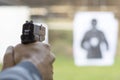 Man Firing Pistol at Target in Shooting Range Royalty Free Stock Photo