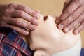 Man In First Aid Class Checking Airway On CPR Dummy Royalty Free Stock Photo