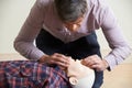 Man In First Aid Class Performing Mouth To Mouth Resuscitation O