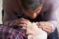 Man In First Aid Class Performing Mouth To Mouth Resuscitation O Royalty Free Stock Photo