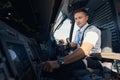 Man first officer pressing button on airplane control panel Royalty Free Stock Photo