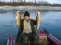 man with a fish catch on a boat. Wild fishing on the river.