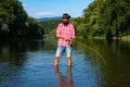 Man fisherman catches a fish. Fly fishing. Brown trout being caught in fishing net. American angler fishing. Brown trout Royalty Free Stock Photo