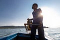 Man fisherman rides a boat with a motor