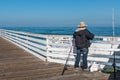 Man Fishes On Top of Crystal Pier in Pacific Beach Royalty Free Stock Photo