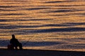 Man Fishing Alone in the Sea at Sunrise or Sunset