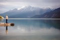 Man Fishing in an Alpine Lake Royalty Free Stock Photo