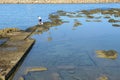 Man fishing at the beach in the center of Porto Torres on Sardinia, Italy Royalty Free Stock Photo