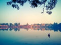 Man fishing on Bindu Sagar lake at sunset