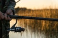 A man is fishing from a boat on sunset. Close-up of hands and rods Royalty Free Stock Photo