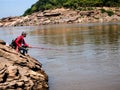 Ubon Ratchathani,05 December 2011 , The man is fishing on cliff of the Grand Canyon of Thailand Stone mountain at Sam Phan Bok,T