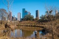 A man fishing in front of downtown Houston view