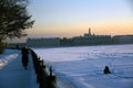 A man fishing on a frozen Neva river in historical city center of Saint-Petersburg