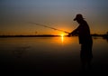 Man fishing on a lake from the boat at sunset Royalty Free Stock Photo